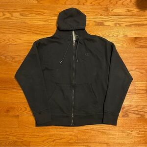 Black Champion zip-up hoodie with a relaxed fit